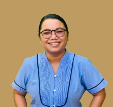 Shierra smiling, wearing glasses and a light blue blouse